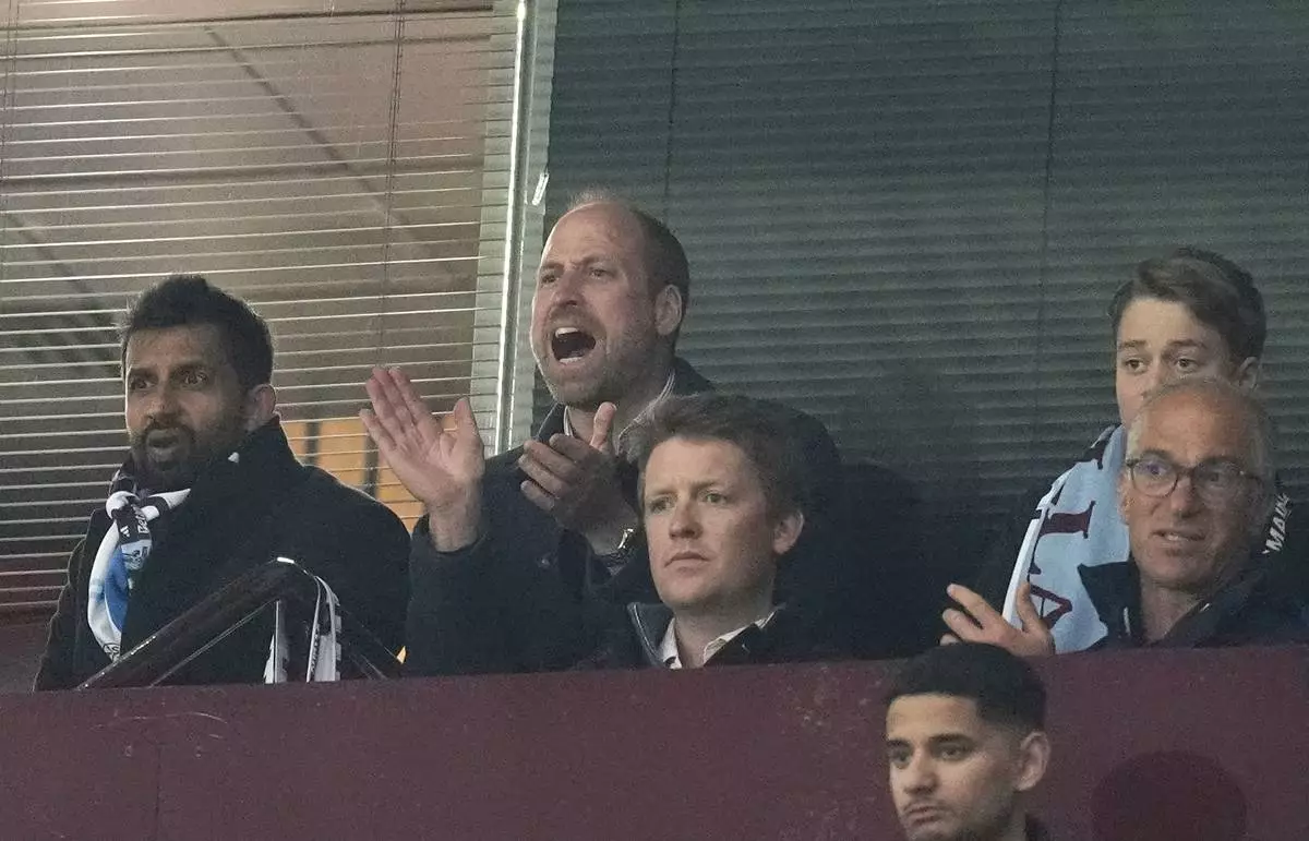 Britain's Prince William, centre, and Prince George, top right, support Aston Villa during the Champions League quarterfinal second leg soccer match between Aston Villa and Paris Saint-Germain at the Villa Park stadium, in Birmingham, England, Tuesday, April 15, 2025. (Nick Potts/PA via AP)