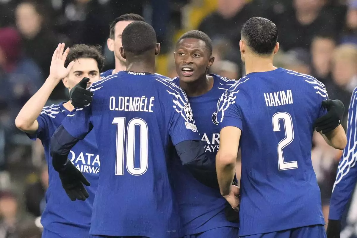 PSG's Nuno Mendes celebrates after scoring his side's second goal during the Champions League quarterfinal second leg soccer match between Aston Villa and Paris Saint-Germain at the Villa Park stadium, in Birmingham, England, Tuesday, April 15, 2025. (AP Photo/Frank Augstein)