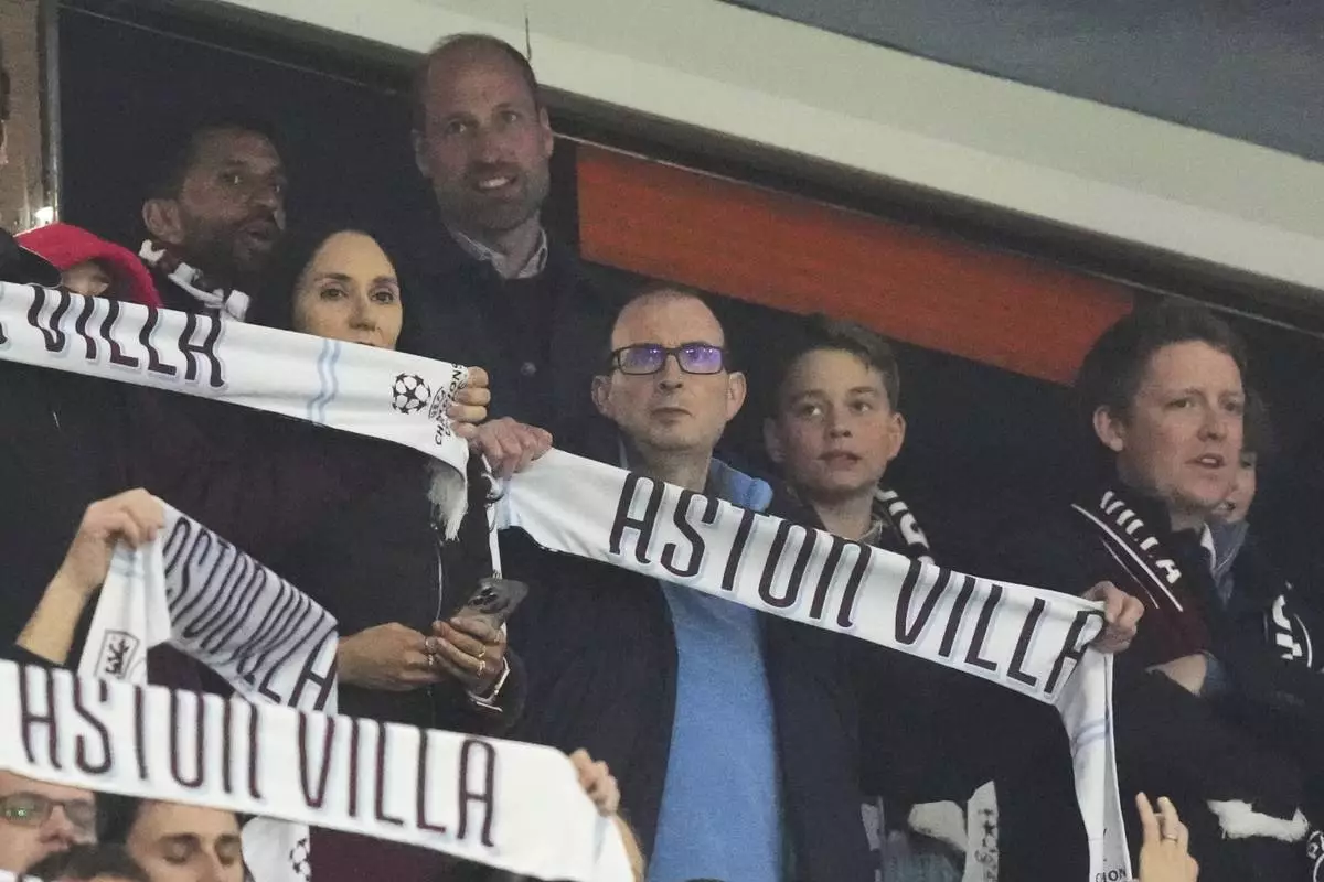 Britain's Prince William and Prince George attend the Champions League quarterfinal second leg soccer match between Aston Villa and Paris Saint-Germain at the Villa Park stadium, in Birmingham, England, Tuesday, April 15, 2025. (AP Photo/Frank Augstein)