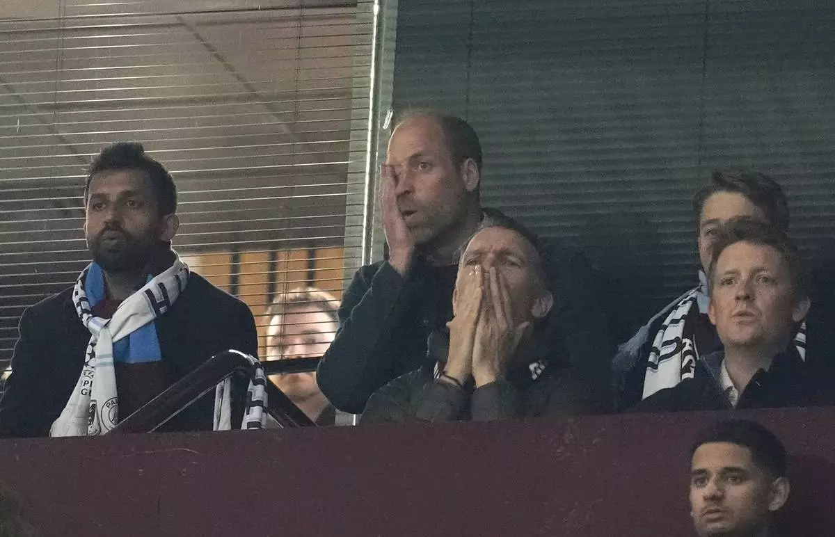 CORRECTS PHOTOGRAPHER'S NAME - Britain's Prince William, centre top, reacts during the Champions League quarterfinal second leg soccer match between Aston Villa and Paris Saint-Germain at the Villa Park stadium, in Birmingham, England, Tuesday, April 15, 2025. (Nick Potts/PA via AP)