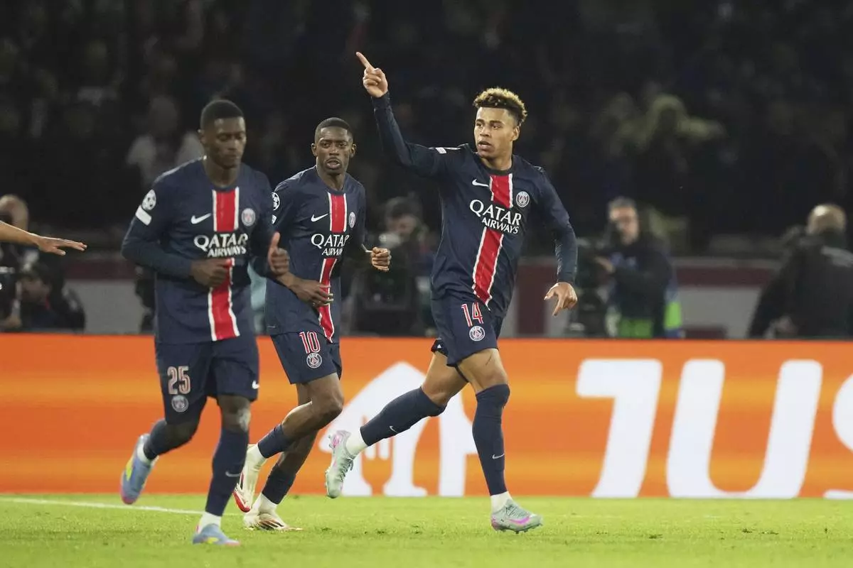 PSG's Desire Doue celebrates after scoring his side's first goal during the Champions League quarterfinal first leg soccer match between Paris Saint-Germain and Aston Villa at Parc des Princes stadium in Paris, Wednesday, April 9, 2025. (AP Photo/Thibault Camus)
