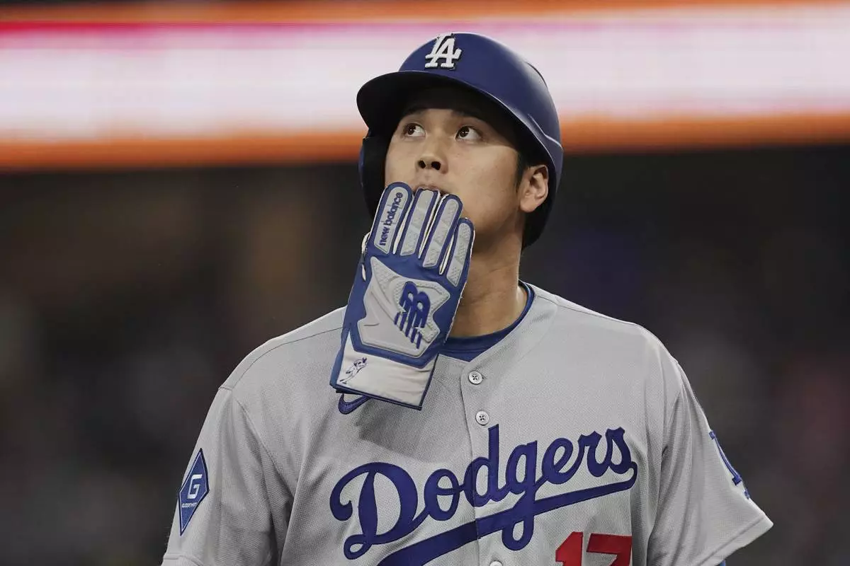 Los Angeles Dodgers' Shohei Ohtani walks off the field and to the dugout after a Teoscar Hernandez fly out in the eighth inning of a baseball game against the Texas Rangers in Arlington, Texas, Sunday, April 20, 2025. (AP Photo/Tony Gutierrez)