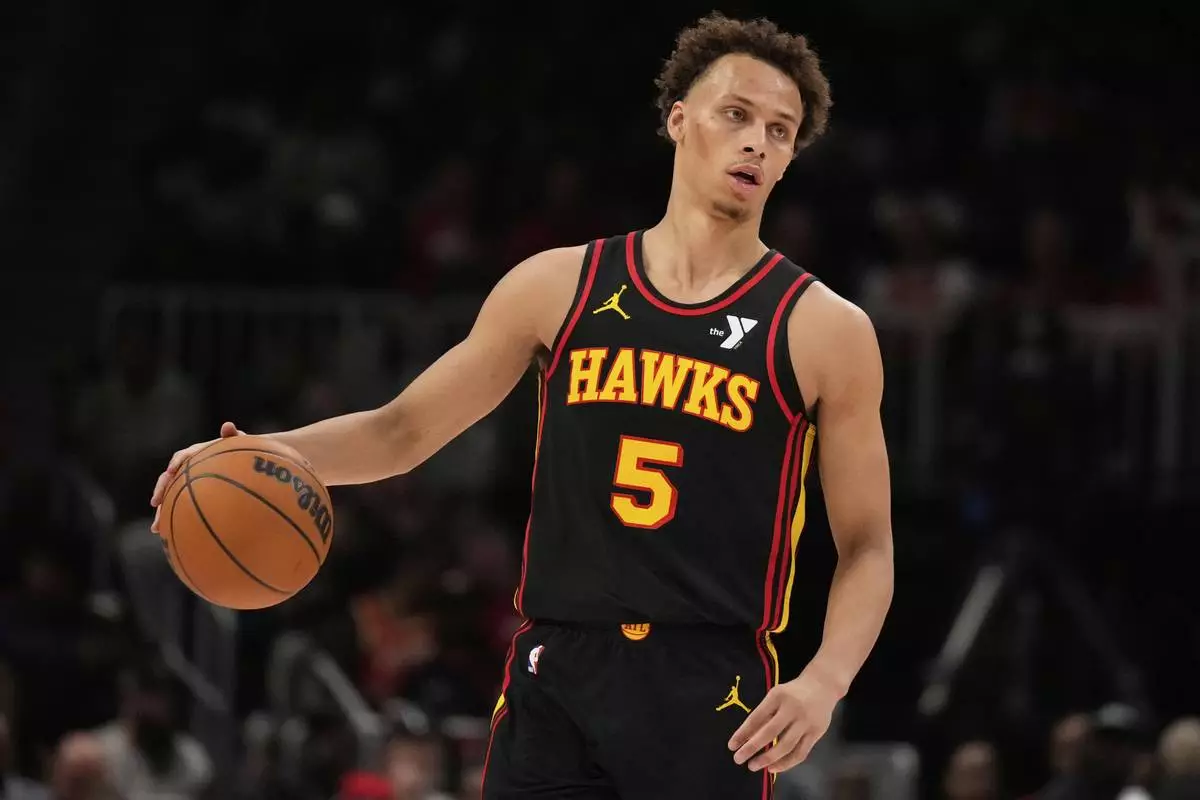 Atlanta Hawks guard Dyson Daniels (5) dribbles in the first half of an NBA play-in tournament basketball game against the Miami Heat, Friday, April 18, 2025, in Atlanta. (AP Photo/Brynn Anderson)