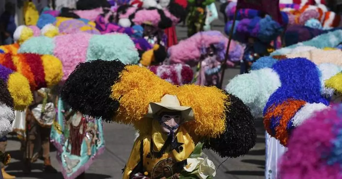 Easter is celebrated with giant caterpillar-like hats and flames in this Mexican town
