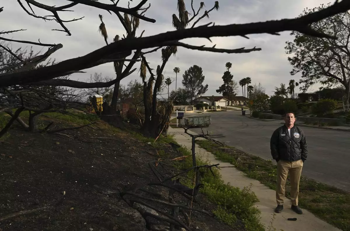Supervisor Jeff Gorrell stands next to damage from the Mountain Fire along Old Coach Drive Wednesday, April 16, 2025, in Camarillo, Calif. (AP Photo/Wally Skalij)