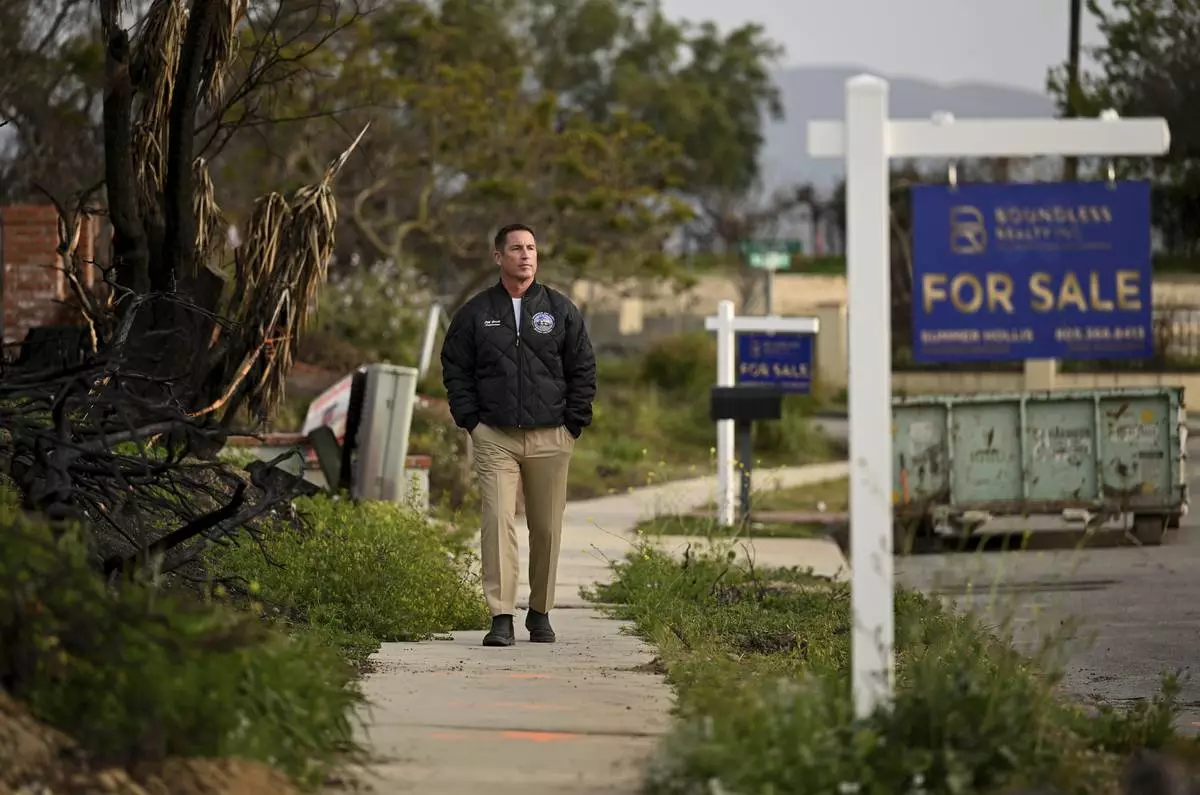 Supervisor Jeff Gorrell walks next to damage from the Mountain Fire along Old Coach Drive in Camarillo Wednesday, April 16, 2025, in Camarillo, Calif. (AP Photo/Wally Skalij)
