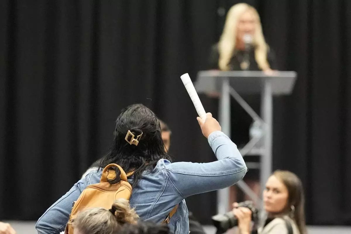 A protester is removed as Rep. Marjorie Taylor Greene, R-Ga., speaks during a town-hall style meeting, Tuesday, April 15, 2025, in Acworth, Ga. (AP Photo/Mike Stewart)