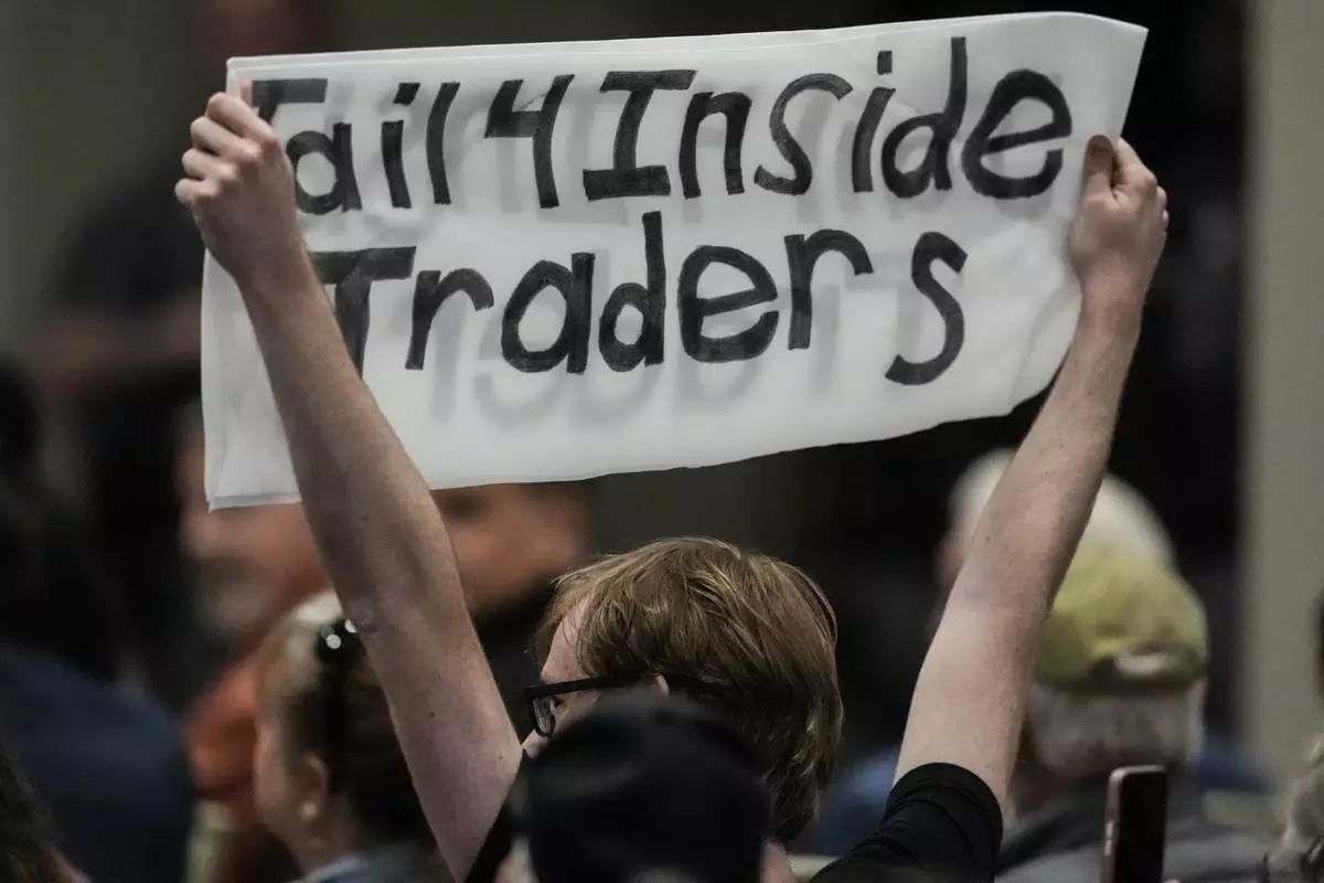 A protester speaks as Rep. Marjorie Taylor Greene, R-Ga., speaks during a town-hall style meeting, Tuesday, April 15, 2025, in Acworth, Ga. (AP Photo/Mike Stewart)