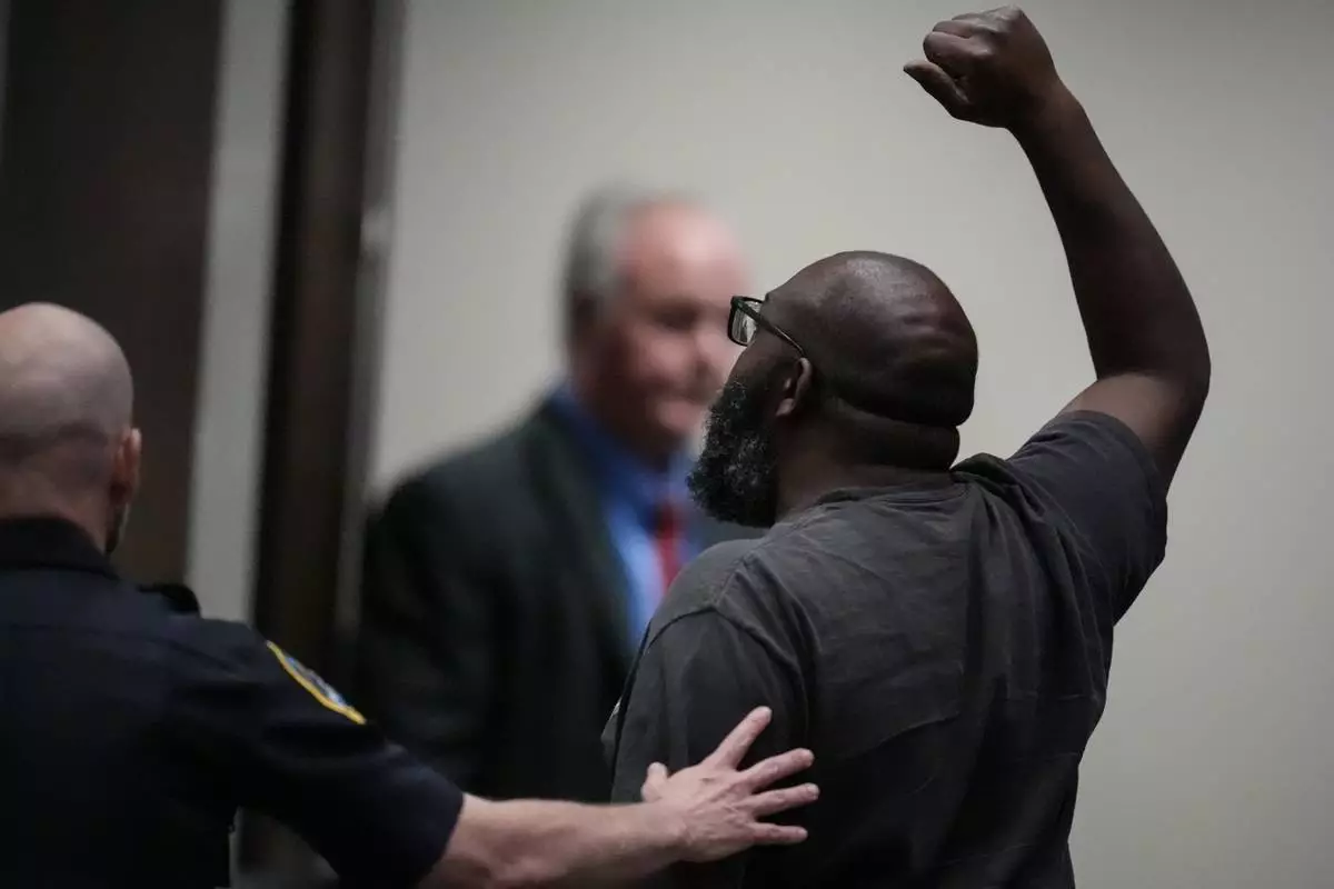 A protester is removed as Rep. Marjorie Taylor Greene, R-Ga., speaks during a town-hall style meeting, Tuesday, April 15, 2025, in Acworth, Ga. (AP Photo/Mike Stewart)
