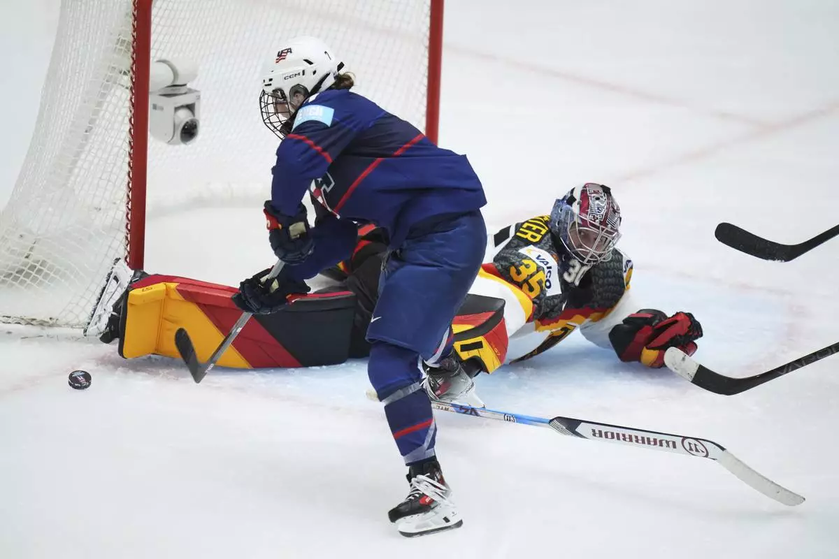 Germany's Sandra Abstreiter, right, makes a save against United States' Lacey Eden during the quarterfinal match between United States and Germany at the Women's Ice Hockey Championships in Ceske Budejovice, Czech Republic, Thursday, April 17, 2025. (AP Photo/Petr David Josek)