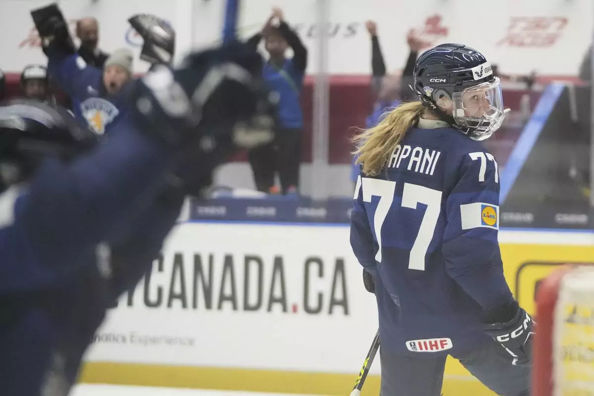 Finland's Susanna Tapani celebrates after scoring her sides third goal during the quarterfinal match between Finland and Sweden at the Women's Ice Hockey Championships in Ceske Budejovice, Czech Republic, Thursday, April 17, 2025. (AP Photo/Petr David Josek)