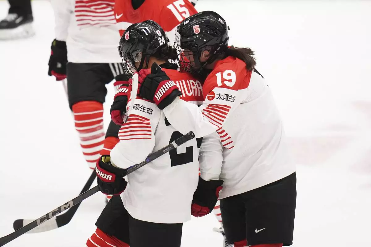 Japan's Mei Miura, left, celebrates with Japan's Makoto Ito after scoring her sides first goal during the quarterfinal match between Canada and Japan at the Women's Ice Hockey Championships in Ceske Budejovice, Czech Republic, Thursday, April 17, 2025. (AP Photo/Petr David Josek)