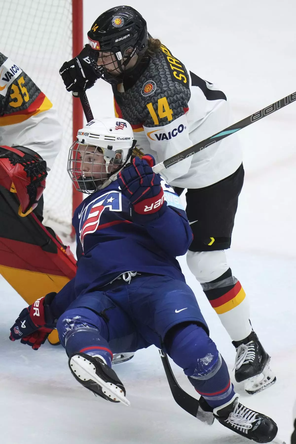Germany's Carina Strobel, back, checks United States' Hilary Knight during the quarterfinal match between United States and Germany at the Women's Ice Hockey Championships in Ceske Budejovice, Czech Republic, Thursday, April 17, 2025. (AP Photo/Petr David Josek)