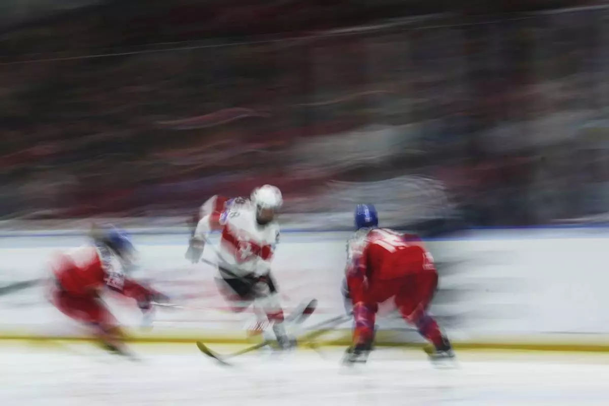 Kaleigh Quennec of Switzerland controls the puck during the quarterfinal match between Czech Republic and Switzerland at the Women's Ice Hockey Championships in Ceske Budejovice, Czech Republic, Thursday, April 17, 2025. (AP Photo/Petr David Josek)