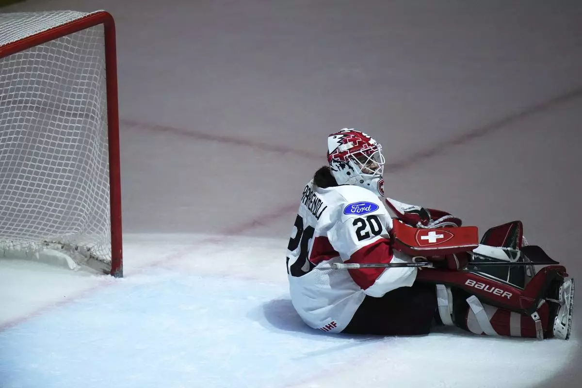 Andrea Braendli of Switzerland sits on ice during the quarterfinal match between Czech Republic and Switzerland at the Women's Ice Hockey Championships in Ceske Budejovice, Czech Republic, Thursday, April 17, 2025. (AP Photo/Petr David Josek)