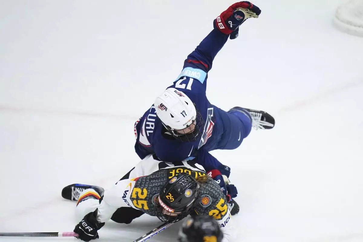 Germany's Laura Kluge, down, collides with United States' Britta Curl during the quarterfinal match between United States and Germany at the Women's Ice Hockey Championships in Ceske Budejovice, Czech Republic, Thursday, April 17, 2025. (AP Photo/Petr David Josek)