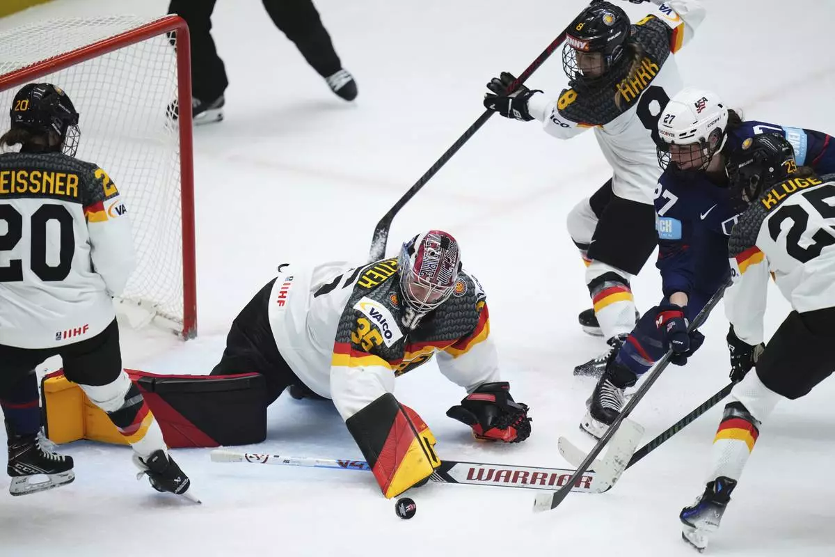 Germany's Sandra Abstreiter makes a save during the quarterfinal match between United States and Germany at the Women's Ice Hockey Championships in Ceske Budejovice, Czech Republic, Thursday, April 17, 2025. (AP Photo/Petr David Josek)