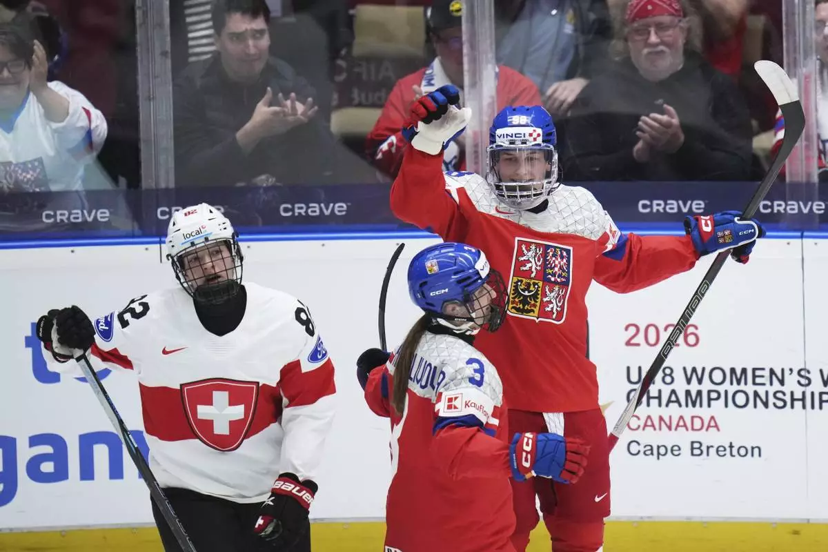 Kristyna Kaltounkova of Czech Republic, right, celebrates after scoring her sides fourth gola during the quarterfinal match between Czech Republic and Switzerland at the Women's Ice Hockey Championships in Ceske Budejovice, Czech Republic, Thursday, April 17, 2025. (AP Photo/Petr David Josek)