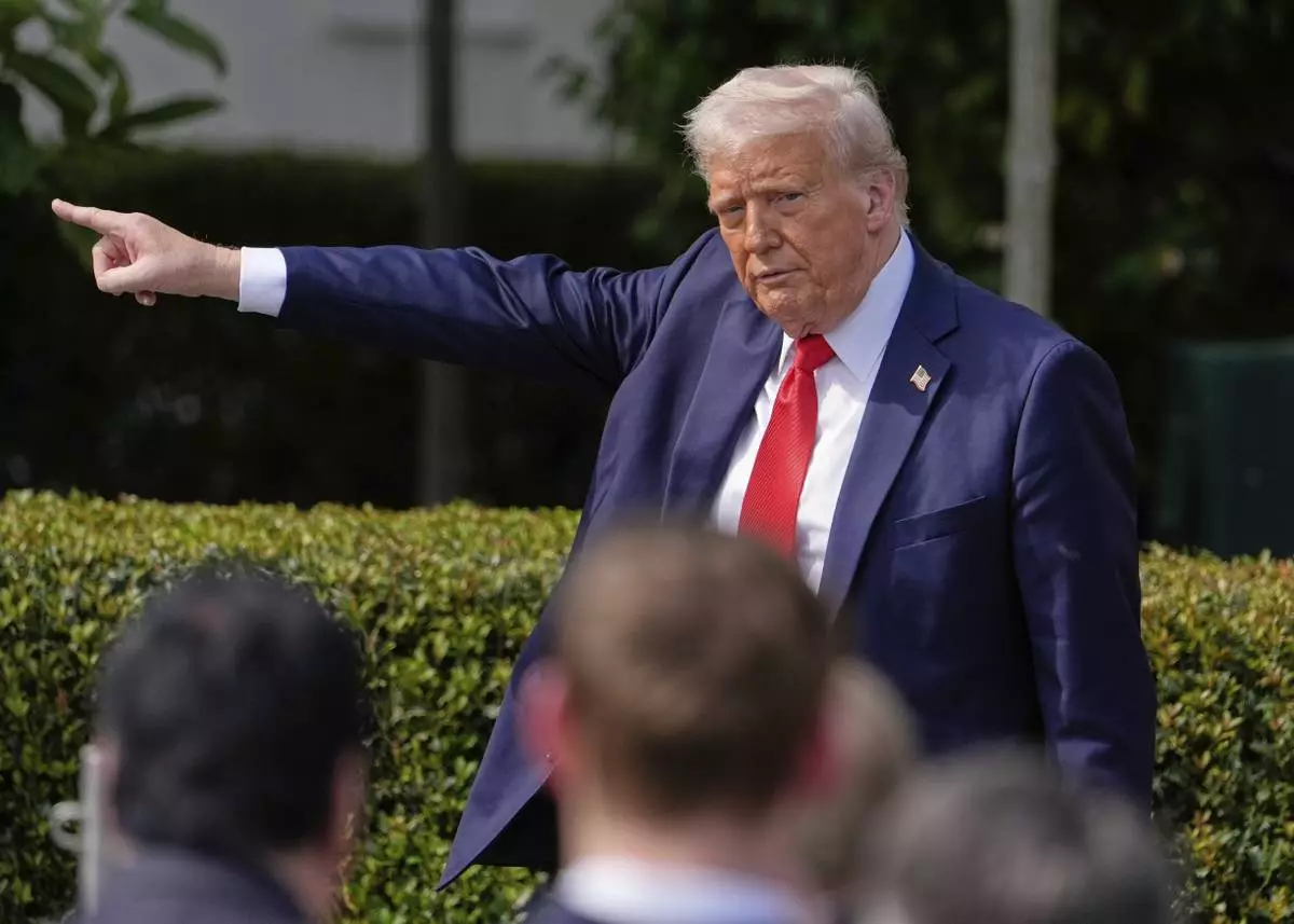 President Donald Trump gestures to the crowd as he departs after welcoming the 2025 College Football National Champions, the Ohio State University football team, during an event on the South Lawn of the White House, Monday, April 14, 2025, in Washington. (AP Photo/Manuel Balce Ceneta)