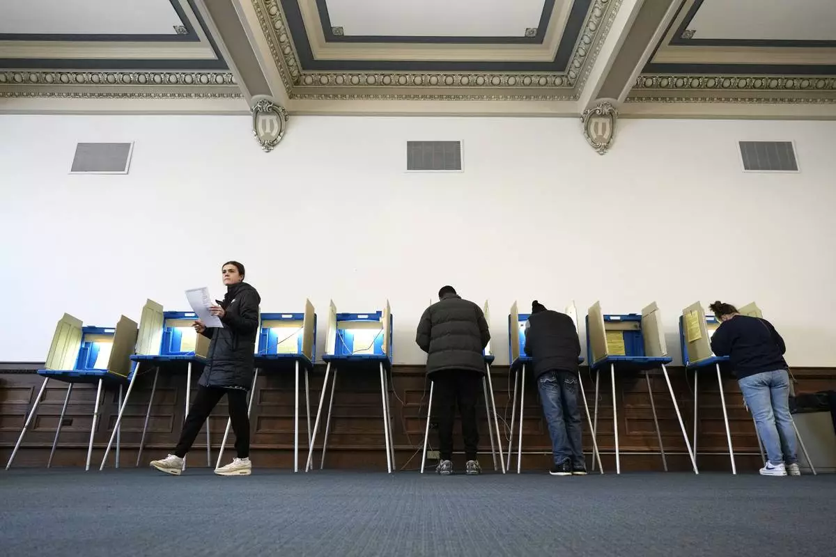 Voters mark their ballots while voting at Centennial Hall at the Milwaukee Central Library on Election Day Tuesday, April 1, 2025, in Milwaukee. (AP Photo/Kayla Wolf)
