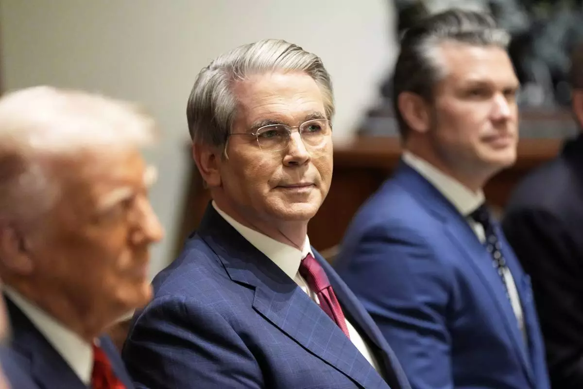 Treasury Secretary Scott Bessent and Defense Secretary Pete Hegseth listen as President Donald Trump speaks before a luncheon with Italy's Prime Minister Giorgia Meloni in the Cabinet Room of the White House, Thursday, April 17, 2025, in Washington. (AP Photo/Alex Brandon)