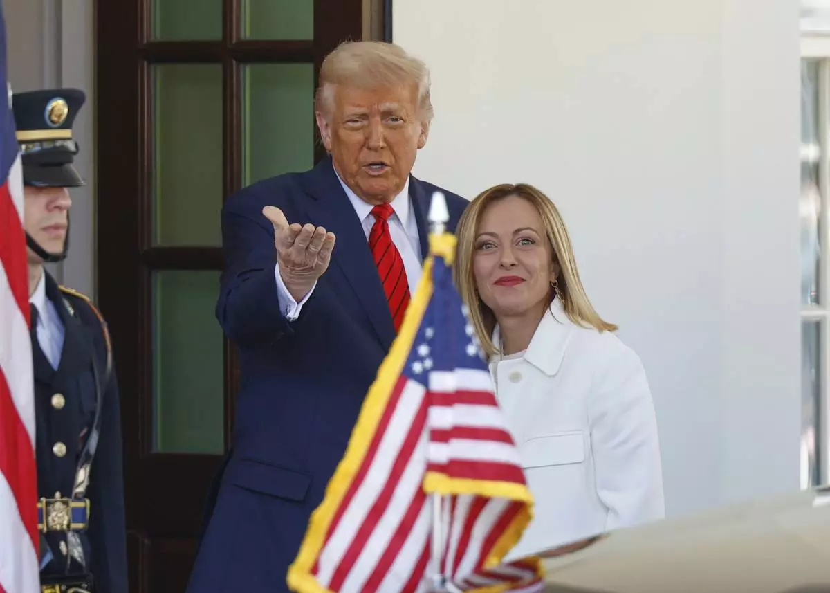 President Donald Trump, center, greets Italy's Prime Minister Giorgia Meloni, right, upon her arrival at the White House, Thursday, April 17, 2025, in Washington. (AP Photo/Tom Brenner)