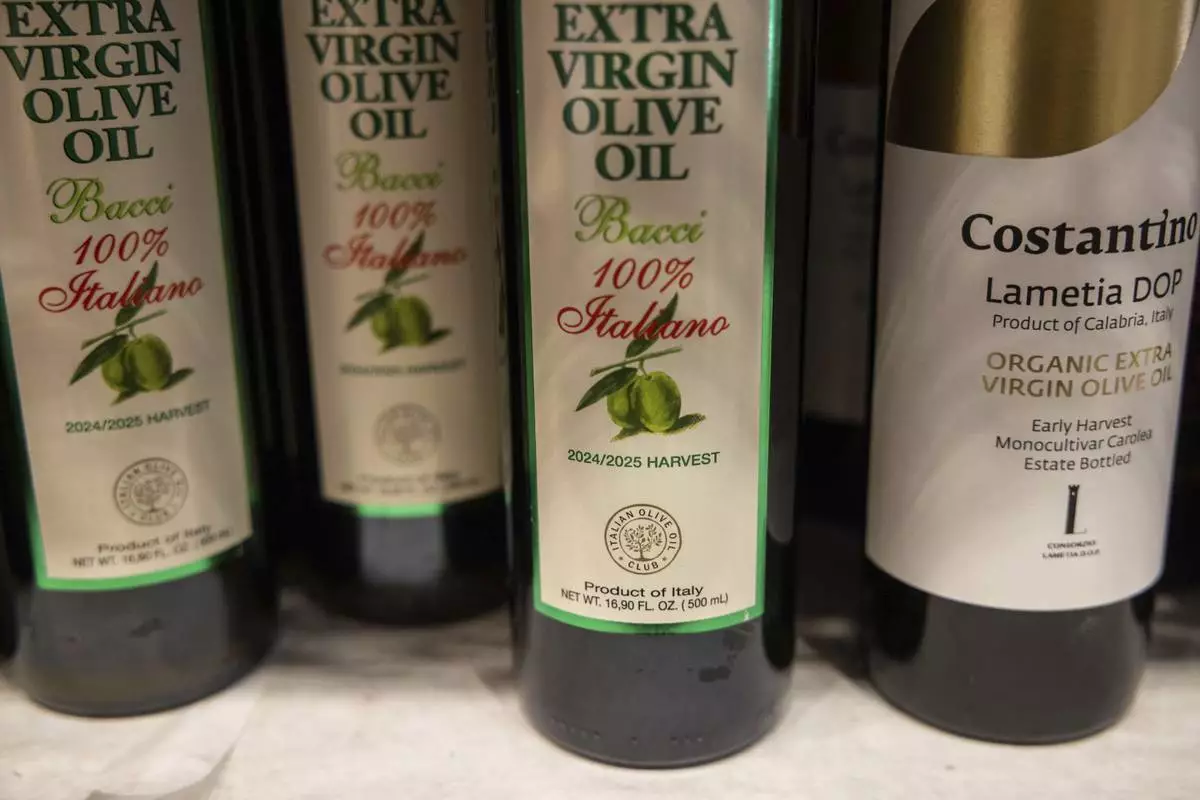 Bottles of olive oil produced in Italy are displayed at Italian grocery store in the Little Italy neighborhood, Wednesday, April 9, 2025, in New York. (AP Photo/Yuki Iwamura)