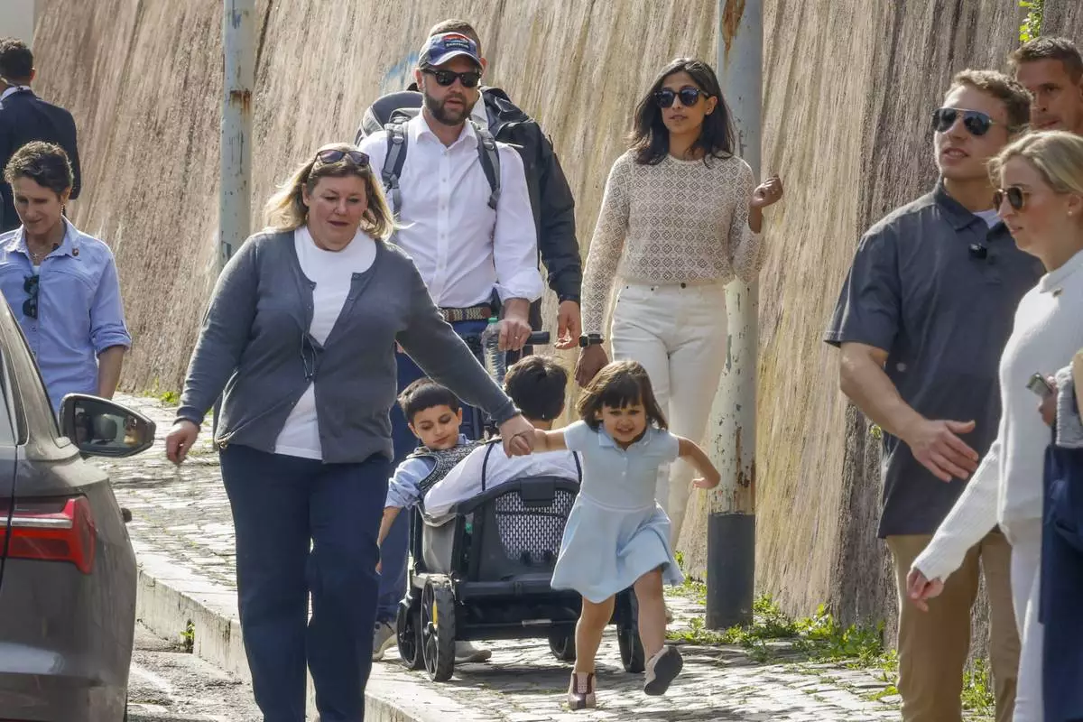 US Vice President J.D. Vance, center, leaves Rome's Botanic Gardens with his wife Usha, right, their daughter Mirabel holding hands with an unidentified staff member, front, and sons Vivek and Ewan, back to camera, Saturday, April 19, 2025. (AP Photo/Riccardo De Luca)