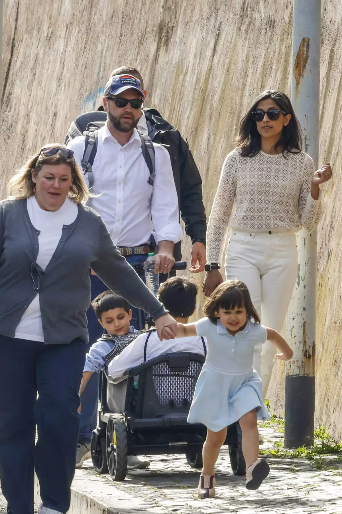US Vice President J.D. Vance leaves Rome's Botanic Gardens with his wife Usha, right, their daughter Mirabel holding hand with an unidentified staff, front, and sons Vivek and Ewan, back to camera, Saturday, April 19, 2025. (AP Photo/Riccardo De Luca)