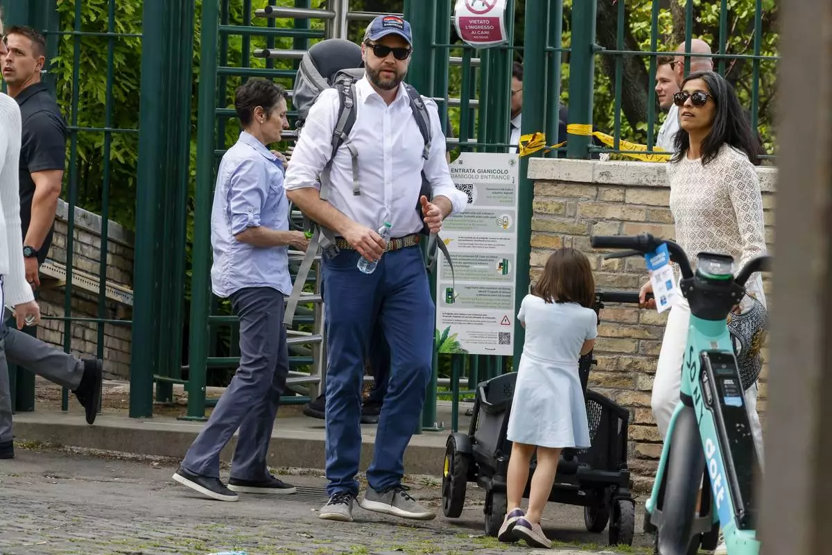 US Vice President J.D. Vance leaves Rome's Botanic Gardens with his wife Usha, right, and their daughter Mirabel, back to camera, Saturday, April 19, 2025. (AP Photo/Riccardo De Luca)