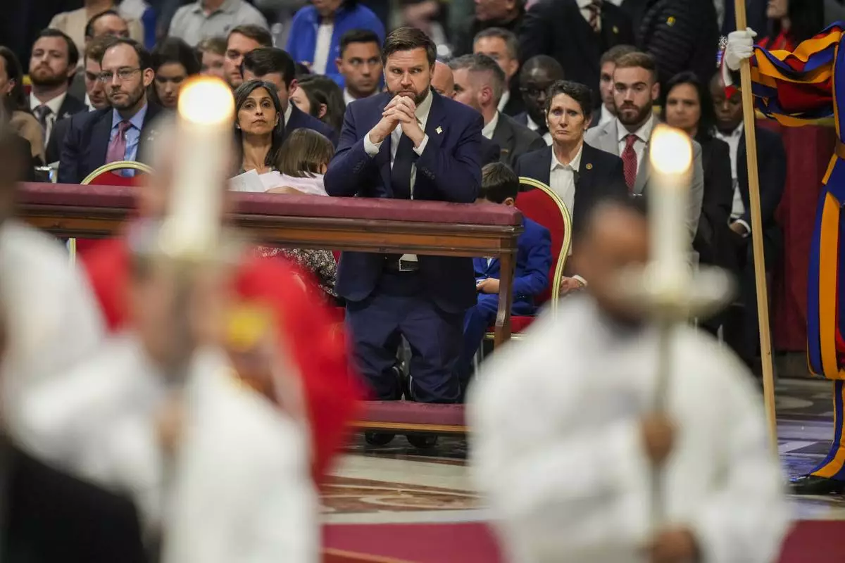 U.S. Vice President JD Vance attends with his wife Usha, left, a Good Friday service inside St. Peter's Basilica at the Vatican, Friday, April 18, 2025. (AP Photo/Alessandra Tarantino)