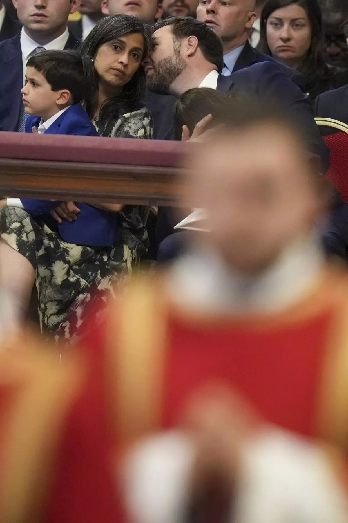 U.S. Vice President JD Vance attends with his wife Usha and son Vivek, left, a Good Friday service inside St. Peter's Basilica at the Vatican, Friday, April 18, 2025. (AP Photo/Alessandra Tarantino)