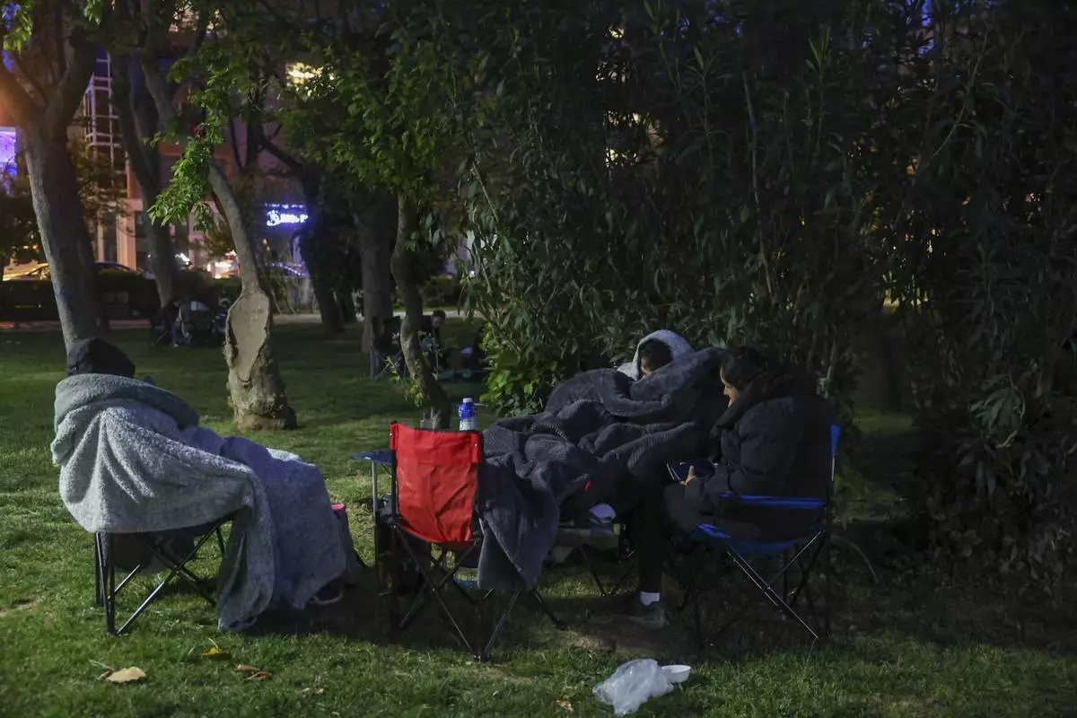 Locals rest in a public park following an earthquake shock with a preliminary magnitude of 6.2, in Istanbul, Turkey, Wednesday, April 23, 2025. (Berkman Ulutin/Dia Photo via AP)
