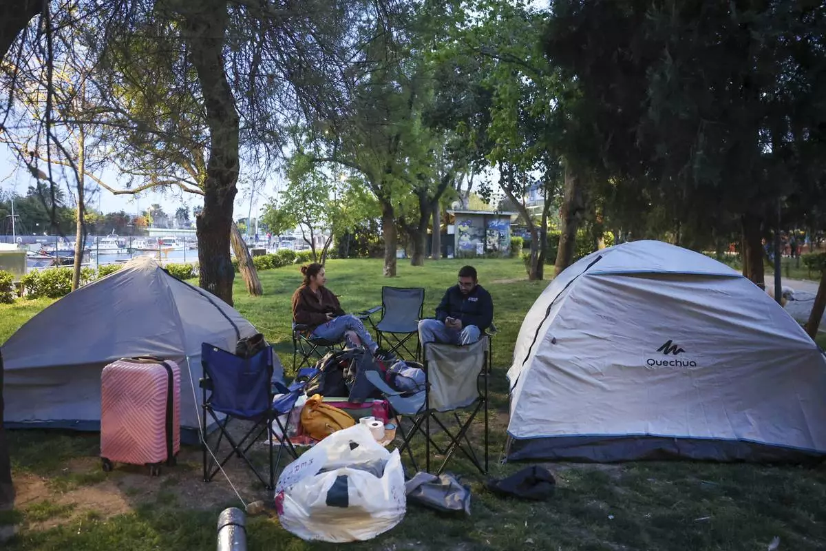Locals camp in a public park following an earthquake shock with a preliminary magnitude of 6.2, in Istanbul, Turkey, Wednesday, April 23, 2025. (Berkman Ulutin/Dia Photo via AP)