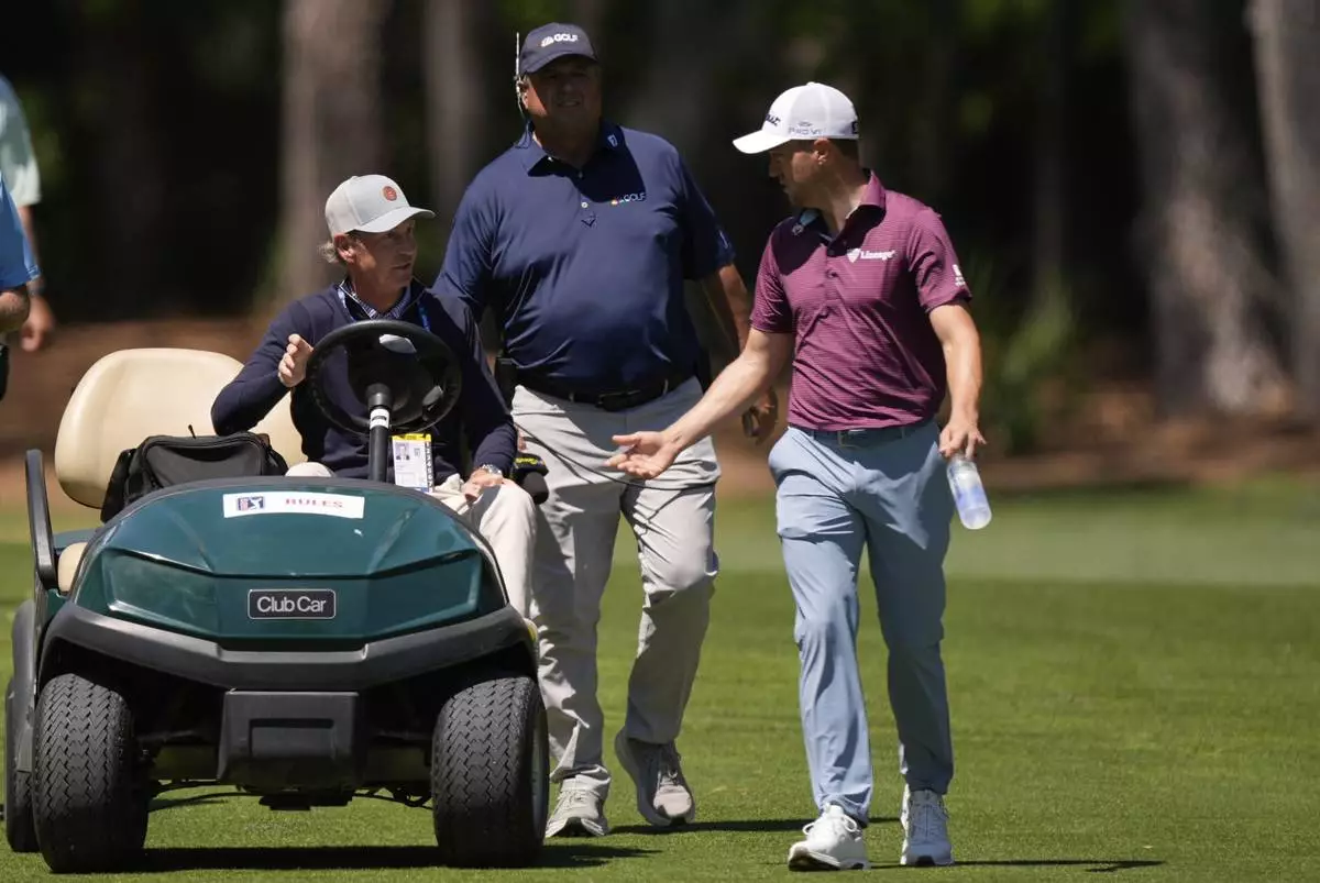 Justin Thomas speaks with an official from the second fairway during the third round of the RBC Heritage golf tournament, Saturday, April 19, 2025, in Hilton Head Island, S.C. (AP Photo/Mike Stewart)