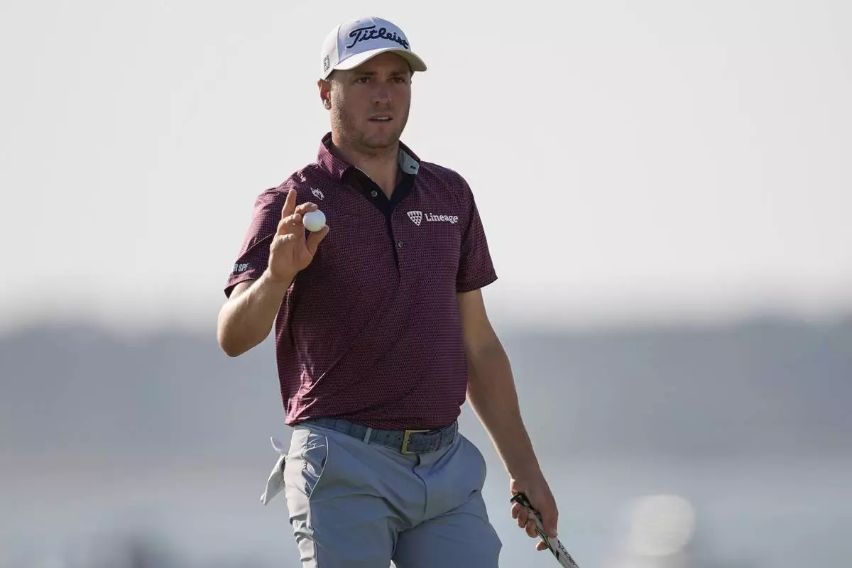 Justin Thomas departs the 18th green during the third round of the RBC Heritage golf tournament, Saturday, April 19, 2025, in Hilton Head Island, S.C. (AP Photo/Mike Stewart)