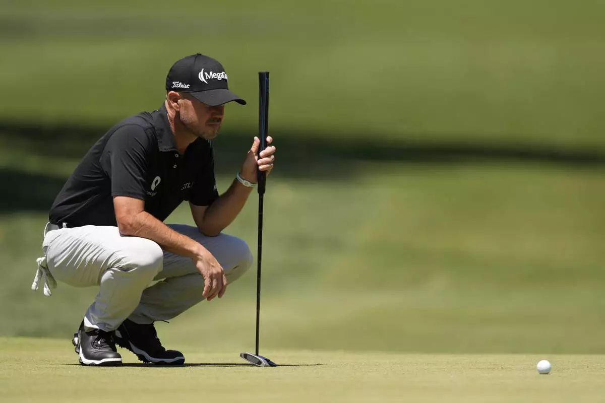 Brian Harman lines up a putt on the second hole during the third round of the RBC Heritage golf tournament, Saturday, April 19, 2025, in Hilton Head Island, S.C. (AP Photo/Mike Stewart)
