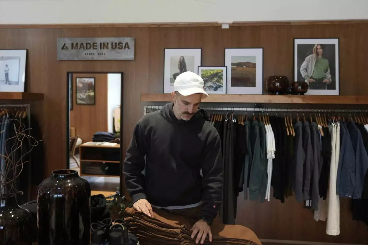 Javid Moghaddasnia, Director of Customer Engagement, discusses American Giant clothing while being interviewed at the company's showroom in San Francisco, Thursday, April 17, 2025. (AP Photo/Jeff Chiu)