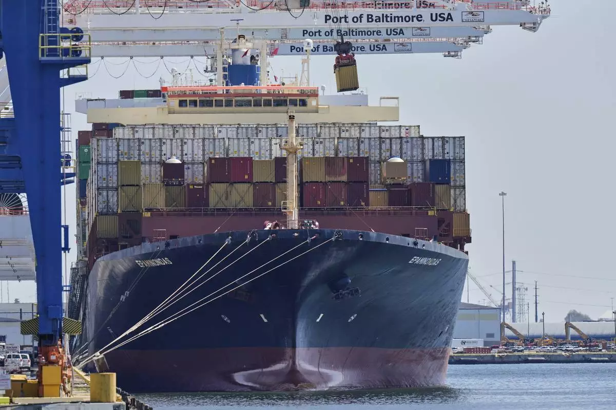 A crane lifts an imports container from the cargo ship Epaminondas while it is docked at the Port of Baltimore, Wednesday, April 9, 2025, in Baltimore. (AP Photo/Stephanie Scarbrough)