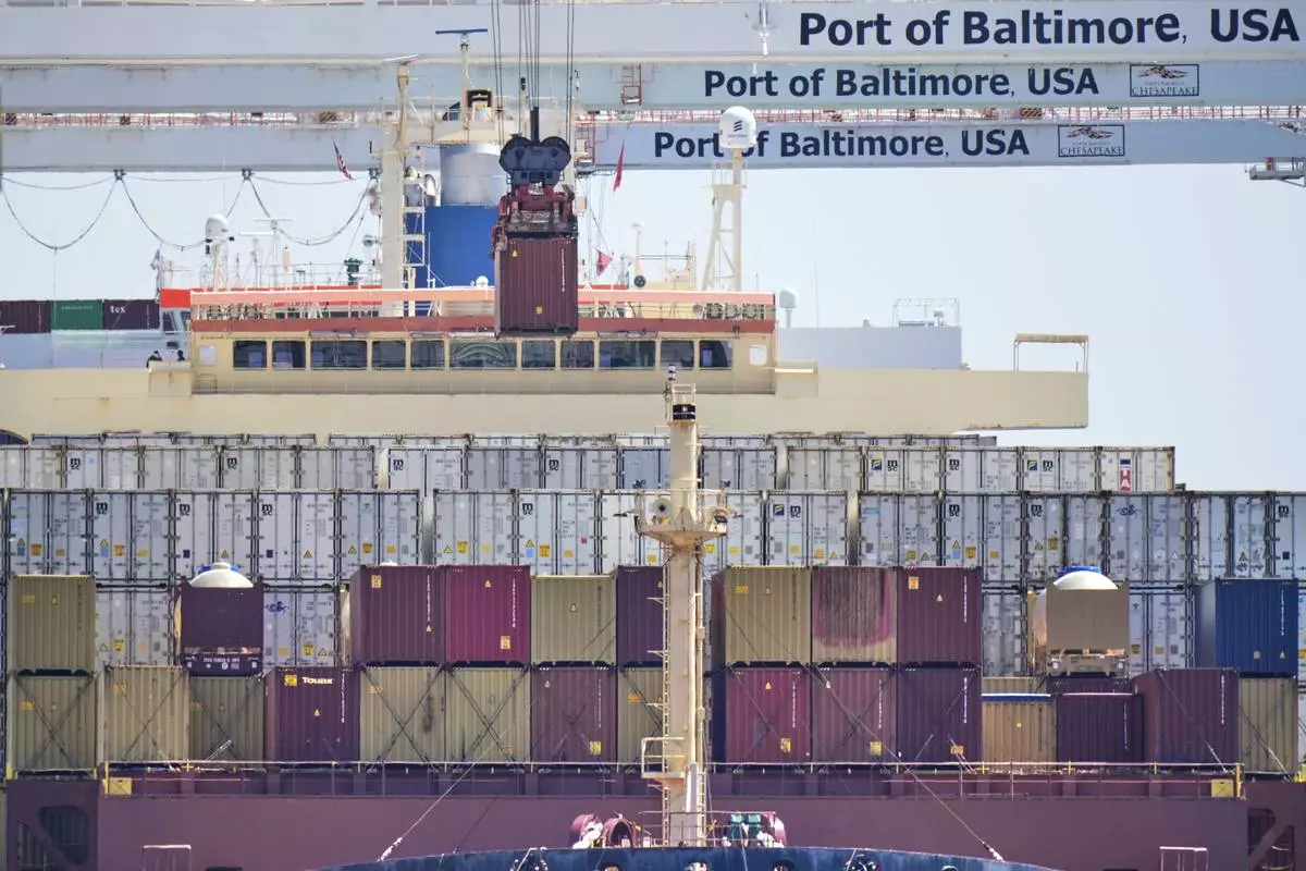 A crane lifts a container from the cargo ship Epaminondas at the Port of Baltimore, Wednesday, April 9, 2025, in Baltimore. (AP Photo/Stephanie Scarbrough)