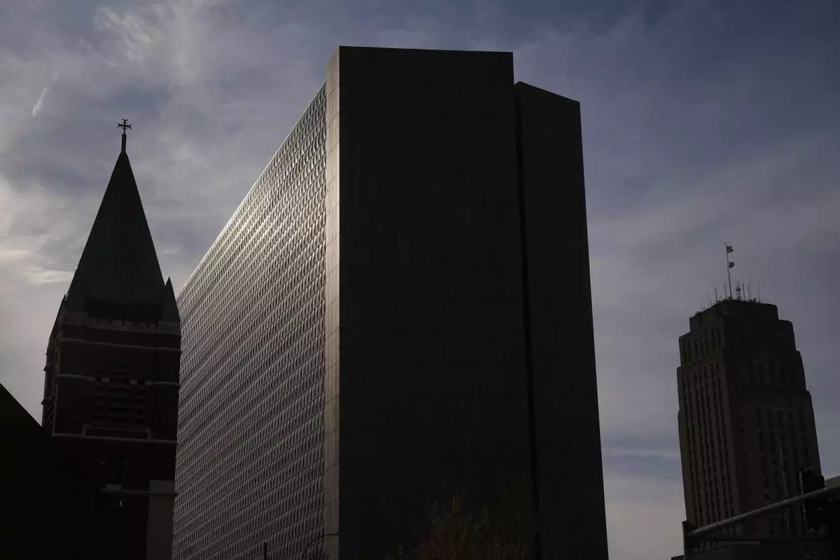 The Richard Bolling federal building, at center, rises among other downtown landmarks, Sunday, April 13, 2025, in Kansas City, Mo. (AP Photo/Charlie Riedel)