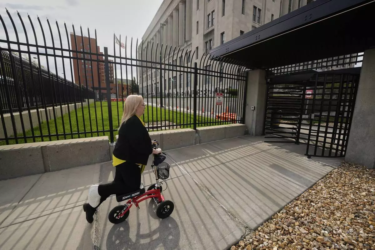 IRS customer service representative Shannon Ellis, goes to work at the processing center where hundreds of her colleagues have taken buyouts and others face potential layoffs, Monday, April 14, 2025, in Kansas City, Mo. (AP Photo/Charlie Riedel)