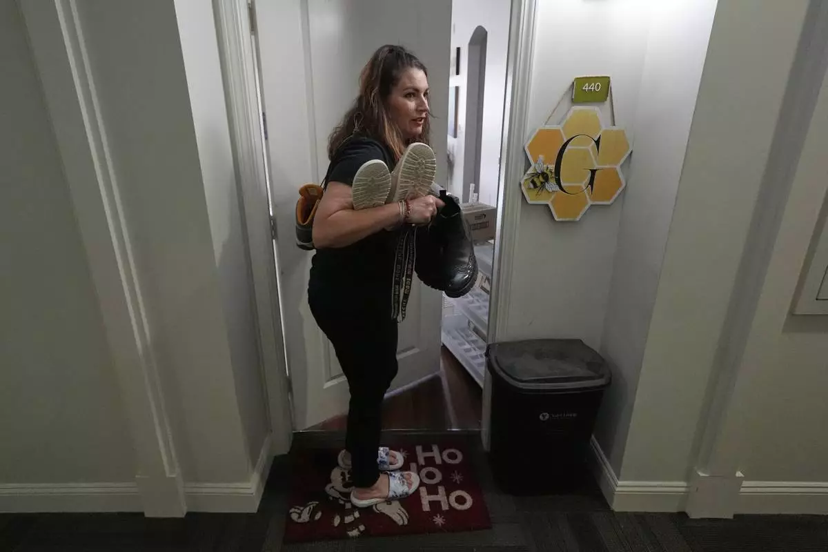 Shea Giagnorio packs belongings in her apartment days after getting fired from her job with the Administration for Children and Families, Monday, April 14, 2025, in Overland Park, Kan. (AP Photo/Charlie Riedel)