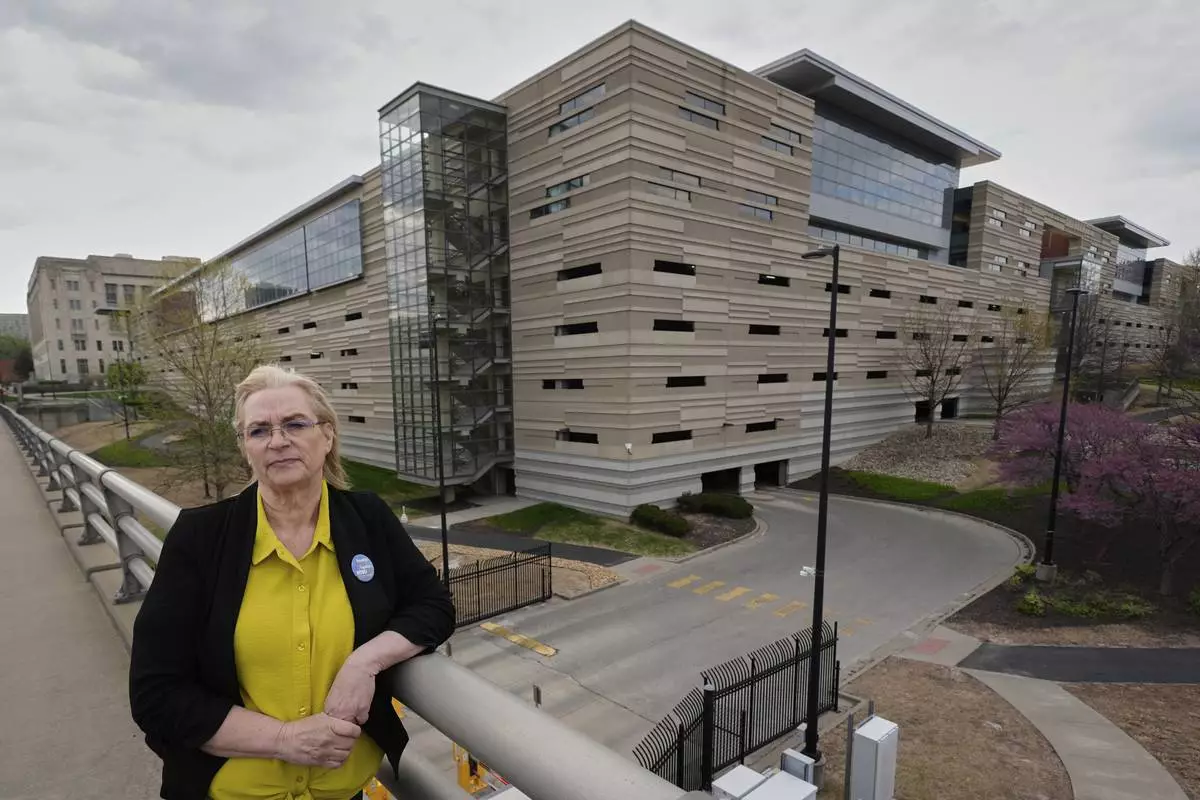 IRS customer service representative Shannon Ellis, stands outside a processing center where hundreds of her colleagues have taken buyouts and others face potential layoffs, Monday, April 14, 2025, in Kansas City, Mo. (AP Photo/Charlie Riedel)