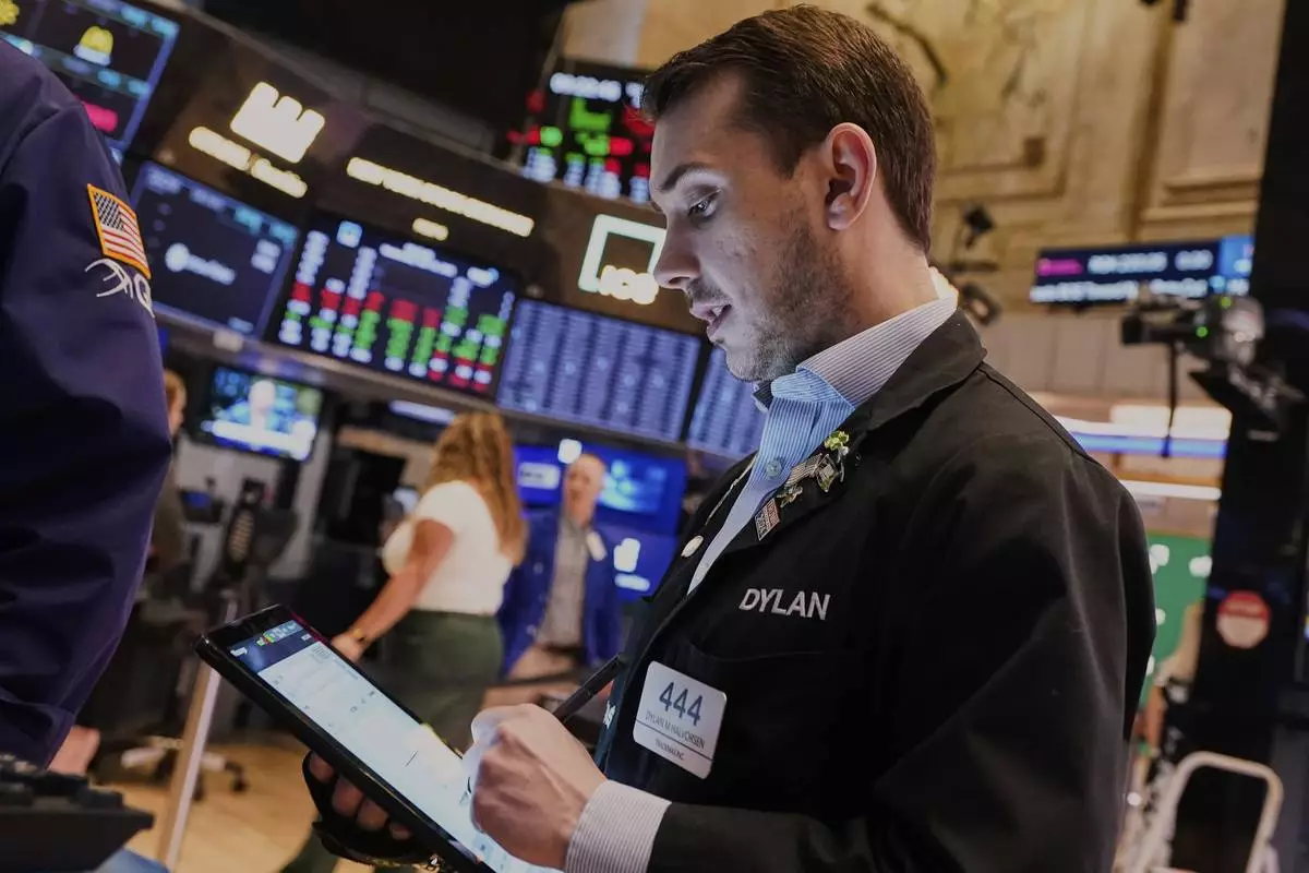 Trader Dylan Halvorsan works on the floor of the New York Stock Exchange, Wednesday, April 16, 2025. (AP Photo/Richard Drew)