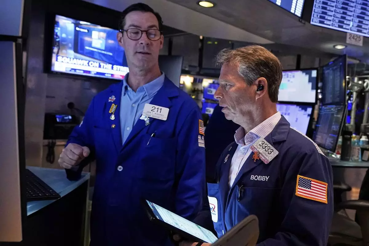 Specialist John McNierney. Left, and trader Robert Charmak work on the floor of the New York Stock Exchange, Wednesday, April 16, 2025. (AP Photo/Richard Drew)