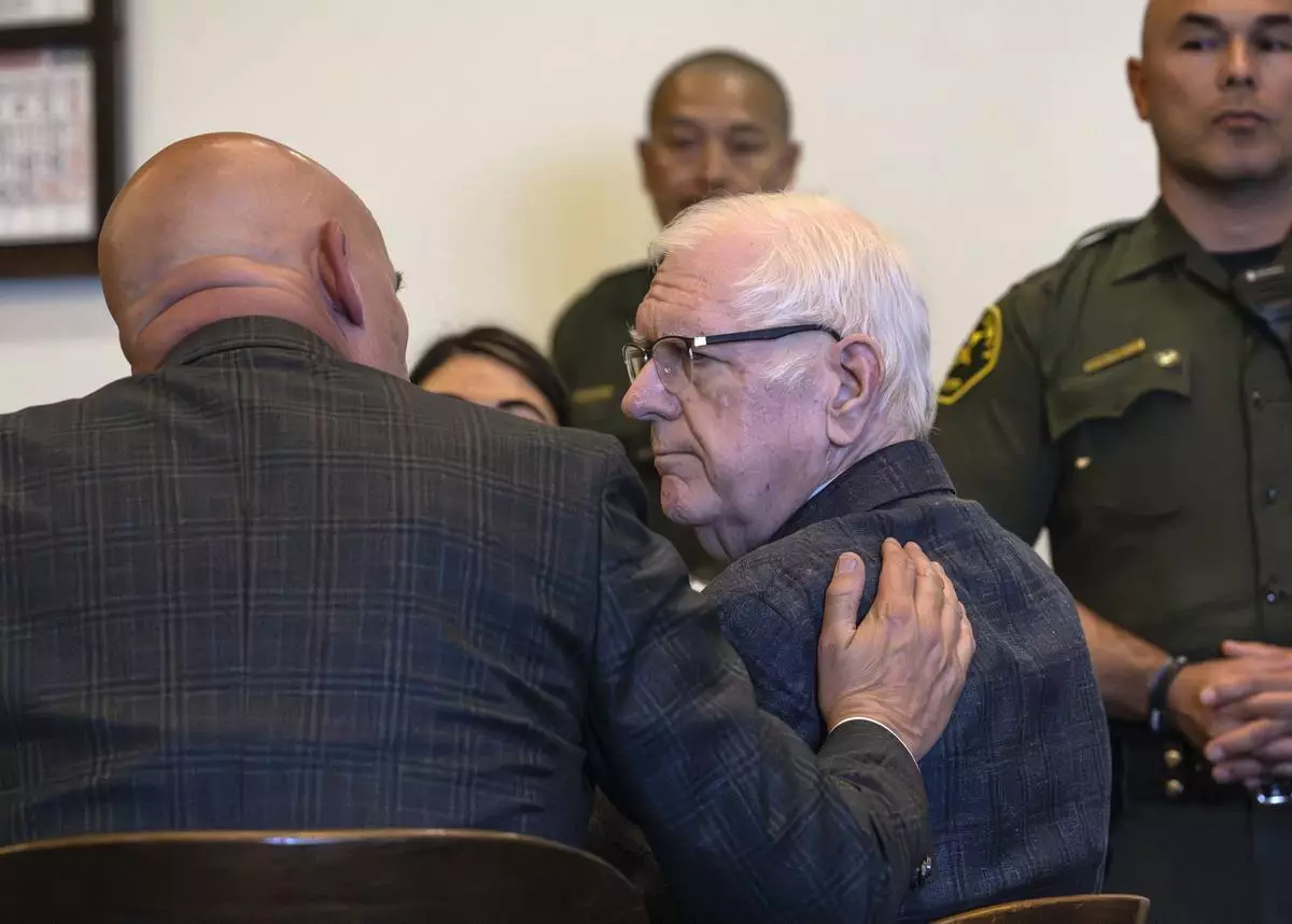 An Orange County Superior Court jury found Orange County Superior Court Judge Jeffrey Ferguson guilty of second-degree murder in the 2023 shooting death of his wife Sheryl Ferguson, is consoled by his attorney, Cameron Talley, after the verdict was read Tuesday, April 22, 2025, in Santa Ana, Calif. (Mindy Schauer/The Orange County Register via AP, Pool)