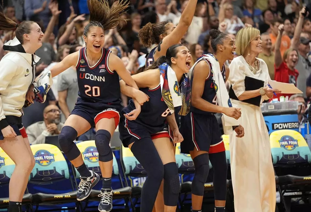 UConn players celebrate during the second half the NCAA womens' title-game against South Carolina, in Tampa, Fla., April 6, 2025. (AP Photo/John Raoux)