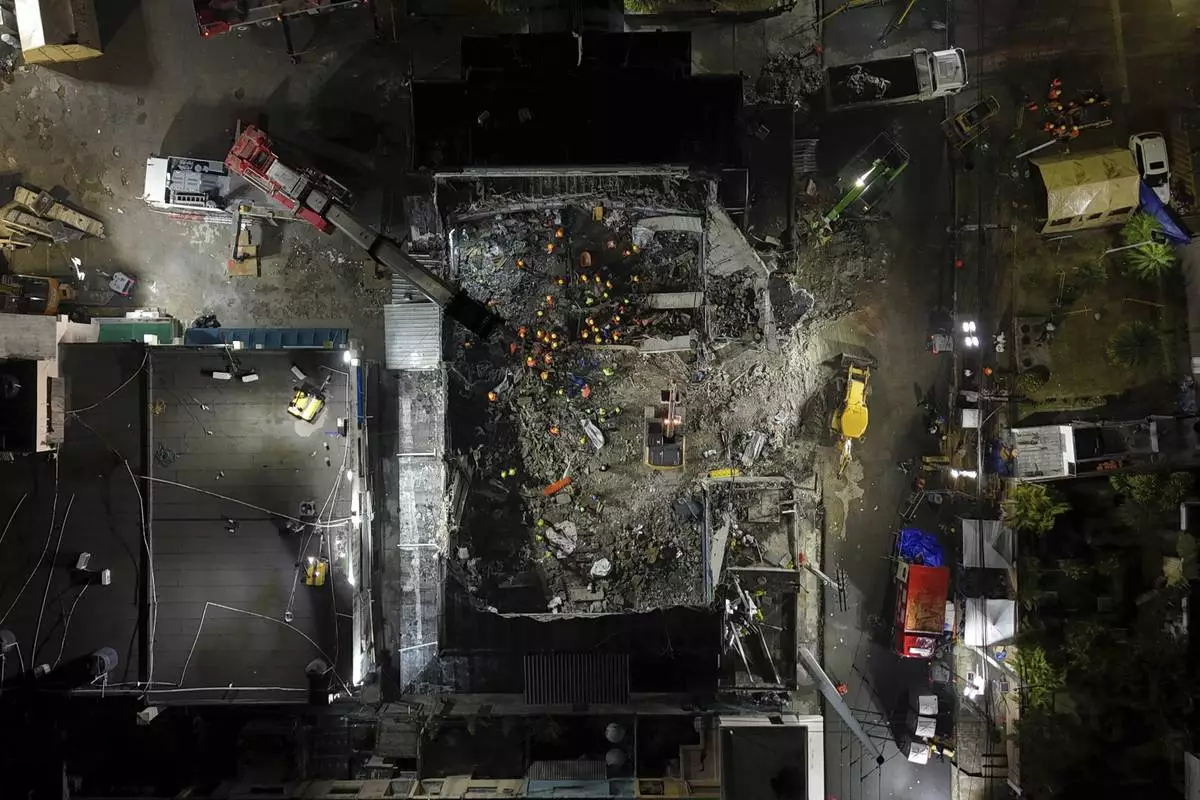 Recovery workers search for bodies at the Jet Set nightclub after its roof collapsed during a merengue concert, in Santo Domingo, Dominican Republic, April 10, 2025. (AP Photo/Matias Delacroix)