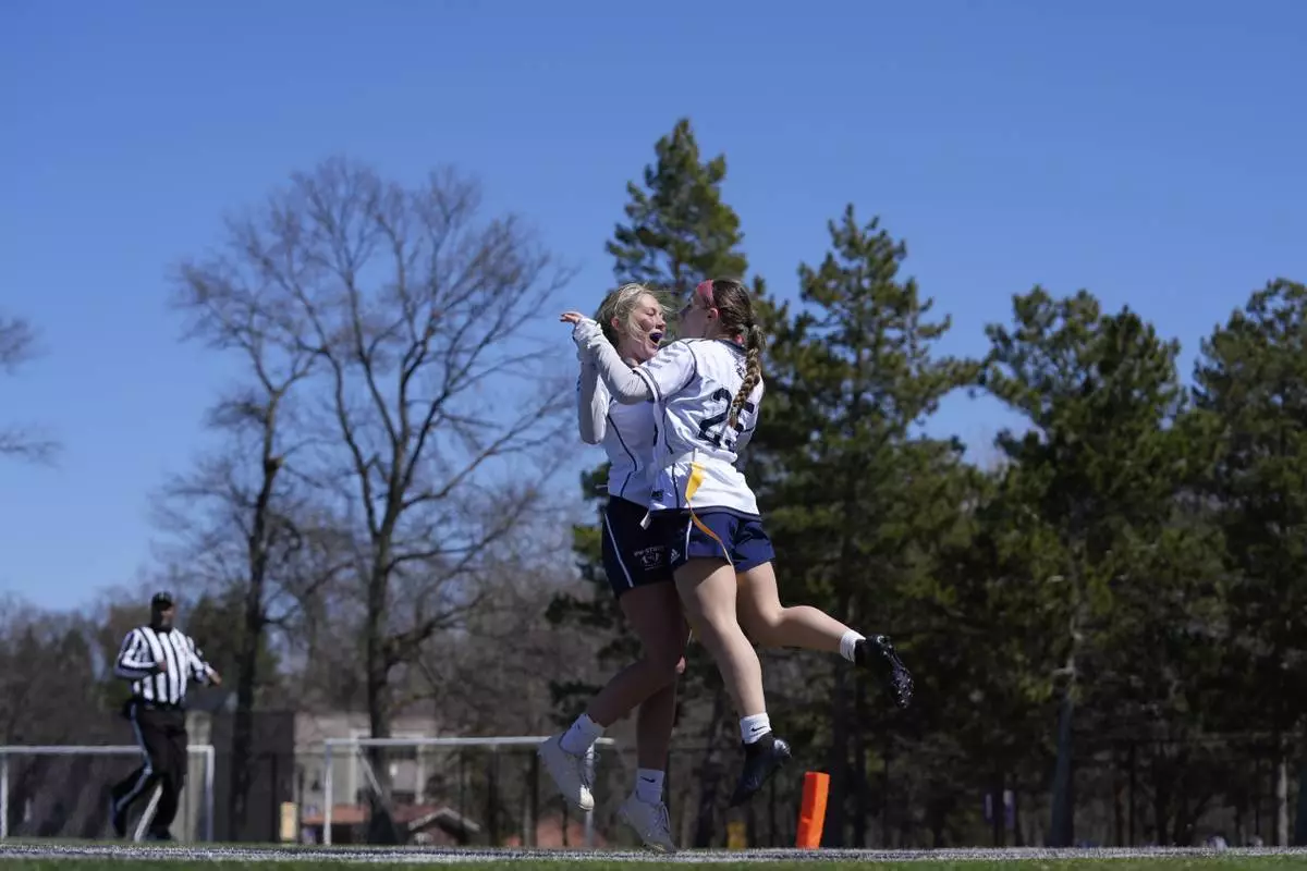 University of Wisconsin - Stout players celebrate during a women's college flag football game against University of Northwestern St. Paul, April 7, 2025, in St. Paul. Minn. (AP Photo/Abbie Parr)